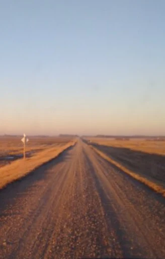 Prairie road at sunset
